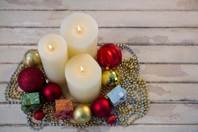 Christmas Candles and Ornaments on Rustic Wooden Plank - Download Free Stock Photos Pikwizard.com