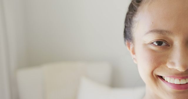 Close-Up of Smiling Young Woman with Minimalist Background - Download Free Stock Images Pikwizard.com