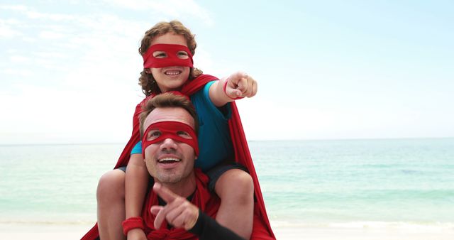 Father and Daughter in Superhero Costumes at Beach Pointing - Download Free Stock Images Pikwizard.com