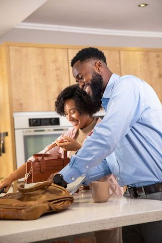 Couple Smiling and Preparing in Elegant Urban Kitchen