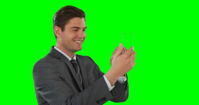 Smiling Businessman Using Transparent Digital Tablet on Green Screen Background - Download Free Stock Images Pikwizard.com