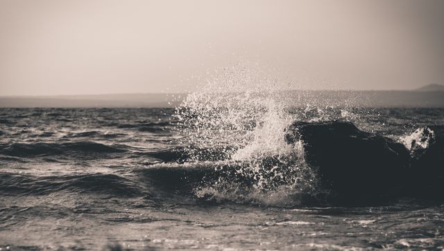 Dramatic Ocean Waves Splashing Over Rock in Black and White - Download Free Stock Photos Pikwizard.com