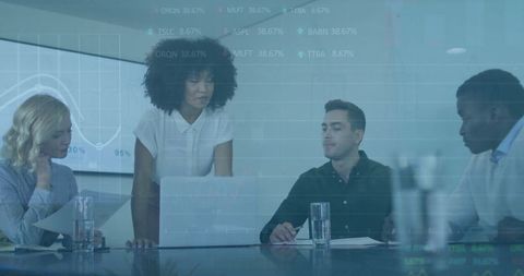 Diverse Team Analyzing Data in Tech-Driven Meeting Room