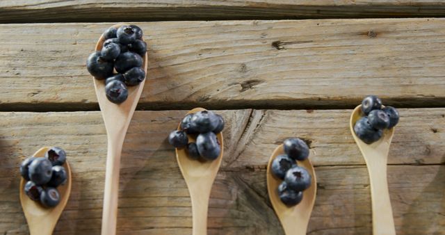 Fresh Blueberries on Wooden Spoons Displayed on Rustic Wooden Surface - Download Free Stock Images Pikwizard.com