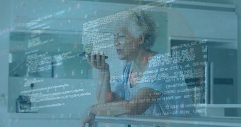 senior woman using speakerphone with computer code overlay - Download Free Stock Images Pikwizard.com