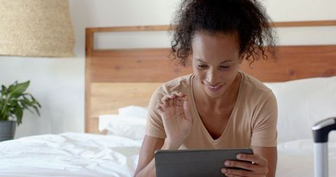 Woman Video Calling on Tablet in Cozy Modern Bedroom