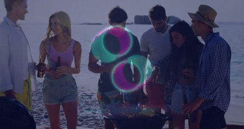 Group of Friends Enjoying Beach Barbecue at Sunset