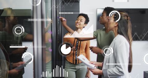 Diverse Team Collaborating with Data Graphics in Modern Office - Download Free Stock Images Pikwizard.com