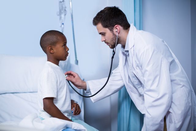 Doctor examining a child with stethoscope in hospital