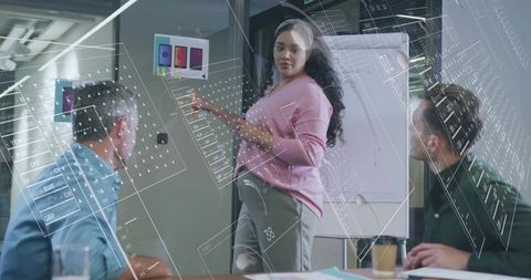 Creative designer presenting color swatches in modern office meeting