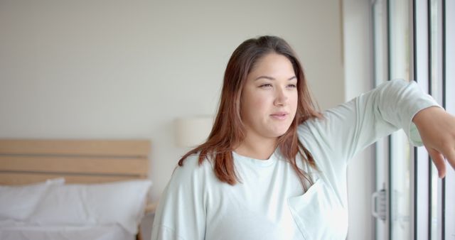 Woman Relaxing Near Window in Cozy Bedroom - Download Free Stock Images Pikwizard.com