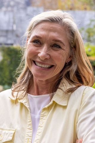 Smiling senior woman enjoying nature in vibrant garden