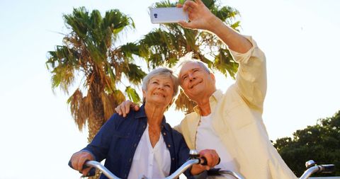 Senior couple enjoying recreation and taking selfie with smartphone