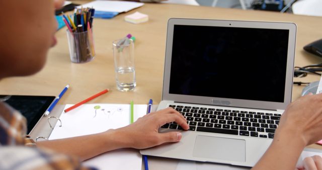 Person Working on Laptop at Desk with Office Supplies - Download Free Stock Images Pikwizard.com