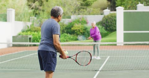 Seniors Enjoying a Tennis Match on Outdoor Court