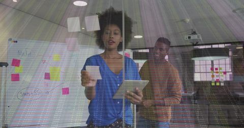 Diverse Team Engaging with Data Visualization in Office