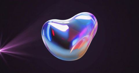 Iridescent holographic bubble on dark studio background