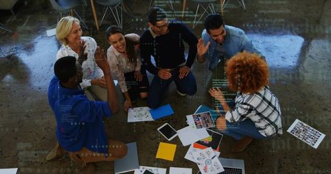 Creative Team High-Fiving in Office, Collaborative Success Celebration