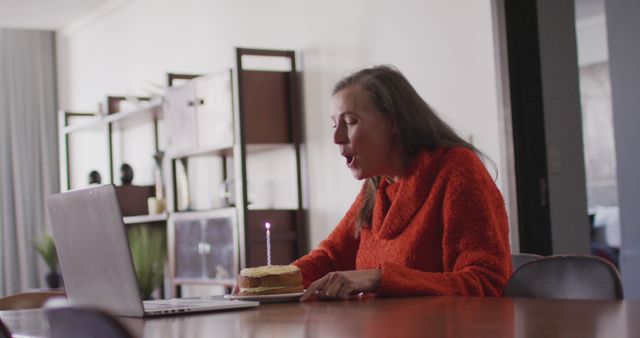 Woman Celebrating Virtual Birthday at Home, Blowing Out Candle - Download Free Stock Images Pikwizard.com