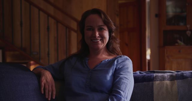 Smiling Woman Relaxing on Couch in Cozy Home Interior - Download Free Stock Images Pikwizard.com