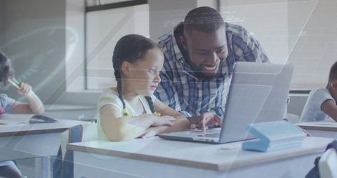 Teacher guiding student on laptop in modern classroom collaborative learning