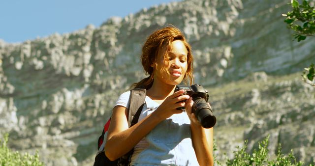 Woman Photographer Exploring Mountains with Camera Equipment - Download Free Stock Images Pikwizard.com