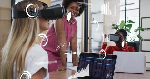 Women collaborating in virtual reality with live data dashboards in modern office