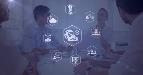 Diverse Business Team Discussing Digital Icons in Modern Office