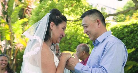Emotional Senior Couple Exchanging Vows in Scenic Garden