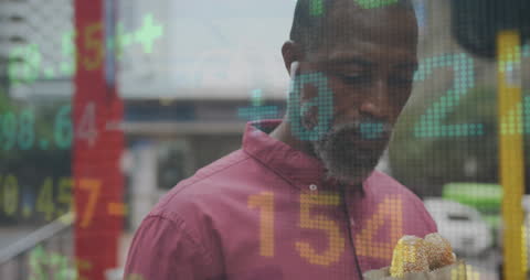 Businessman Eats Sandwich with Financial Data Display