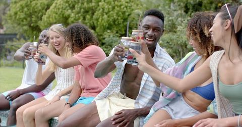 Diverse Friends Cheering with Drinks on Sunny Day Outdoors - Download Free Stock Images Pikwizard.com