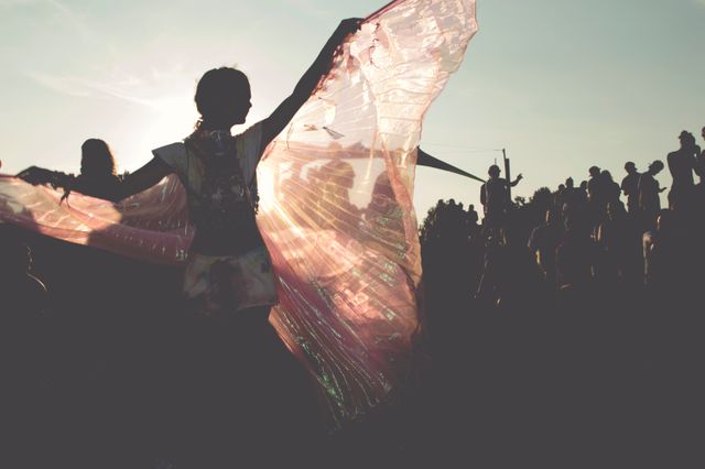 Silhouette of Woman Dancing with Flowing Scarf at Outdoor Festival - Download Free Stock Photos Pikwizard.com