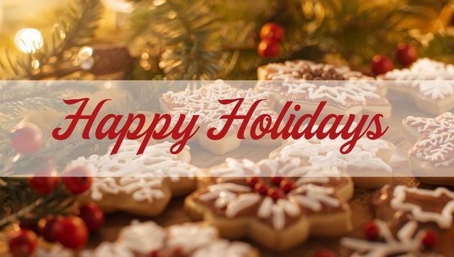 Happy holidays banner with decorated sugar cookies and iced snowflakes on wooden tabletop