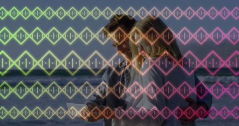 Couple embracing ocean technology concept under neon pattern