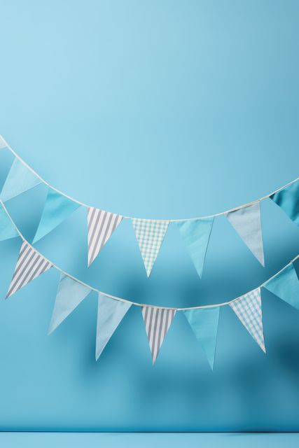 Festive blue and white pennant banner garland features striped and checkered patterns. Ideal for advertising party supplies, event planning materials, celebrations, birthdays, weddings, and other decorative uses.
