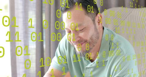 Smiling Asian man using laptop with floating binary overlay in bright home workspace