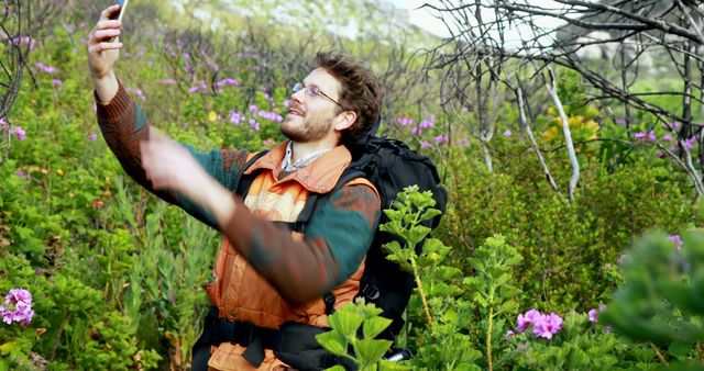 Man Taking Selfie During Hike in Flower-filled Forest - Download Free Stock Images Pikwizard.com