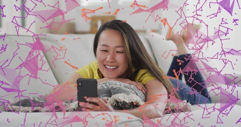 Relaxing on sofa livestreaming with smartphone and colorful polygon tech overlay