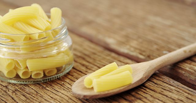 Uncooked Pasta Shells in Glass Jar and Wooden Spoon on Rustic Table - Download Free Stock Images Pikwizard.com