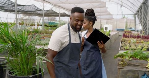 Horticulture experts managing greenhouse operations and plant health