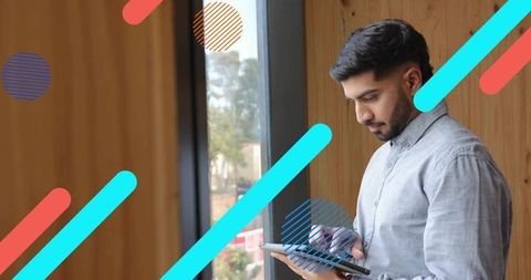 Focused Professional Man Using Tablet in Modern Office Environment