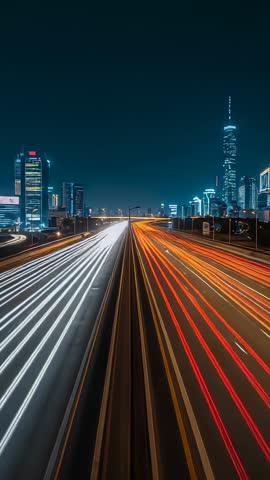 Vertical time-lapse capturing highway light trails racing toward illuminated city skyline at night