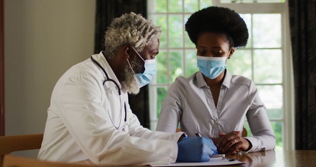 Doctor Consulting Patient in Office Wearing Masks for Health Safety - Download Free Stock Images Pikwizard.com