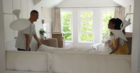 Couple organizing home post-move in bright living room