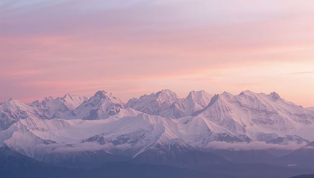 Majestic Snowy Mountains Under a Pastel Sunrise