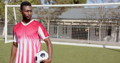 Soccer Player Holding Ball by Goal during Outdoor Practice