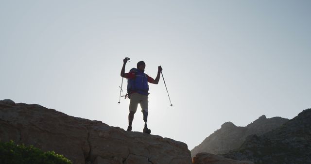 Silhouette of Hiker with Prosthetic Limb Viewing Summit at Sunset - Download Free Stock Images Pikwizard.com