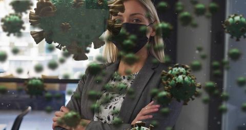 Businesswoman wearing black mask in modern office amid floating coronavirus graphics