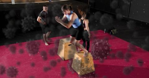 Female athlete jumping and landing on plyo boxes during intense gym plyometric workout