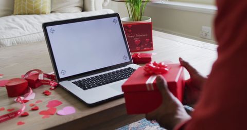 Person Holding Romantic Gift Near Laptop with Valentine's Theme - Download Free Stock Images Pikwizard.com